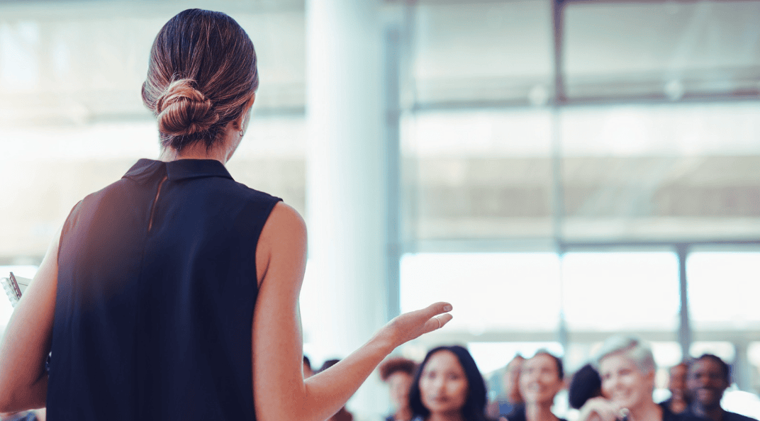 A woman giving a presentation in English during a financed course at Connor Training