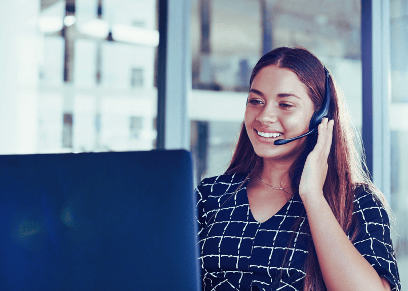 A business woman uses a headset to communicate with her teacher during an online Spanish lesson for corporate language